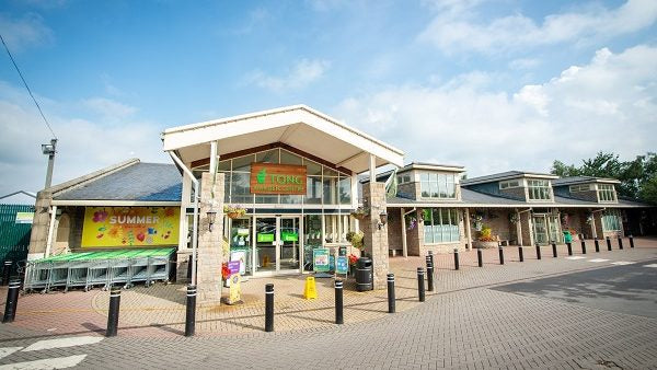 Tong Garden Centre Building under a blue sky.
